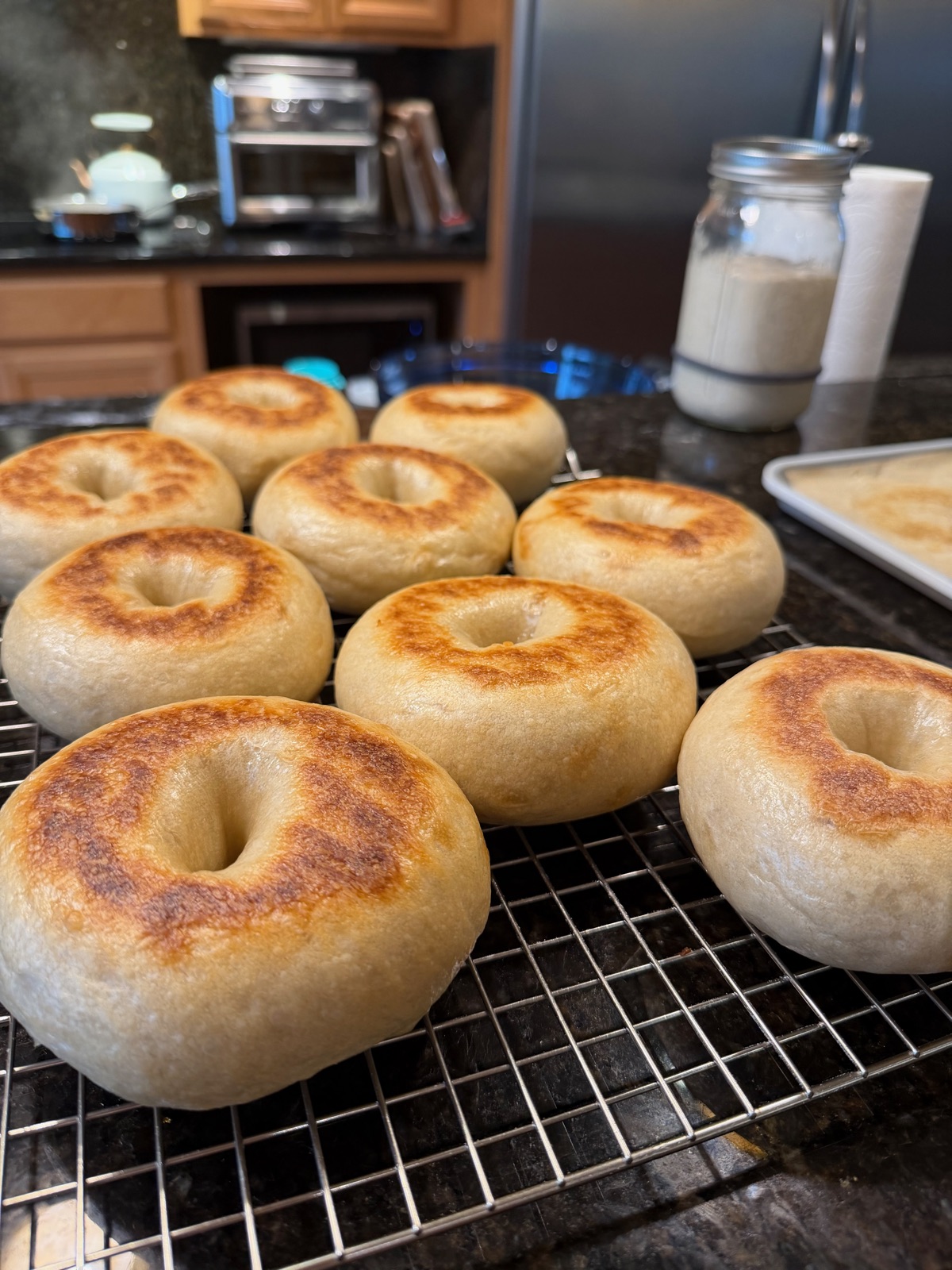 A rack of golden sourdough bagels.